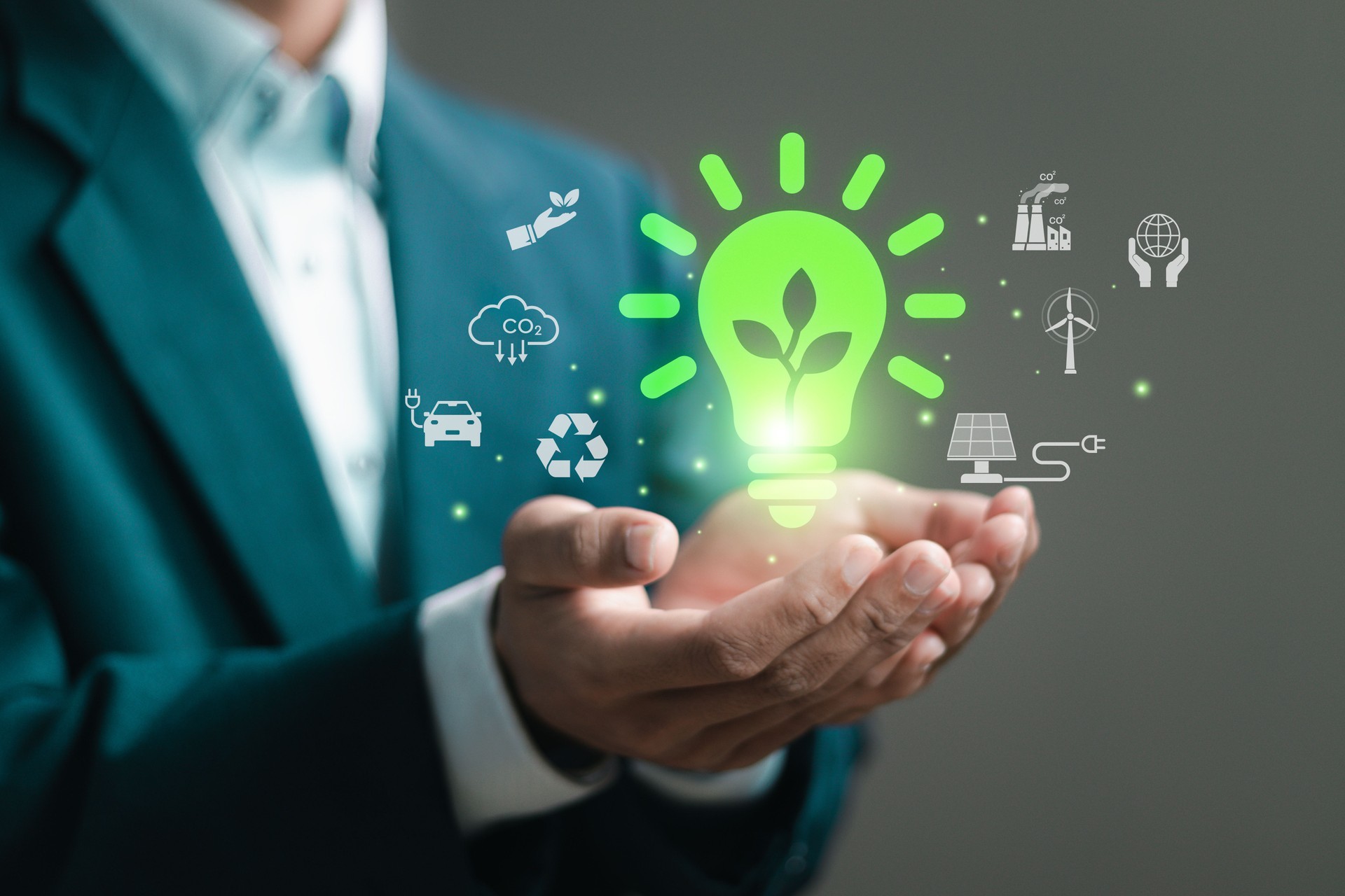 Green energy concept. businessman with light bulb and ESG icons for clean energy. World sustainable environment, sharing, reusing, Renewable and environmental care.